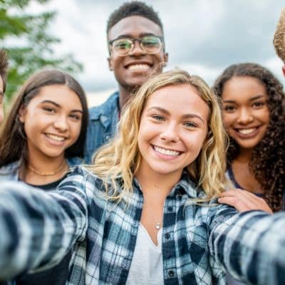 Why choose invisalign over braces for your teen? 9 Group of teens taking a selfie and smiling