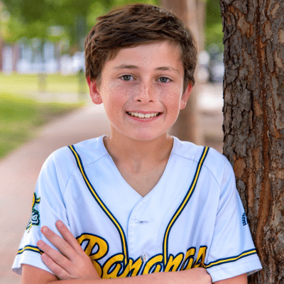 When to call the dentist for baby tooth trauma 3 Little boy in sports jersey by tree, representing when to call the dentist for baby tooth trauma