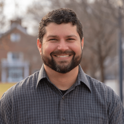 Invisalign for adults in williamsburg 4 Adult patient at jfo posing for a photo outside, representing invisalign for adults